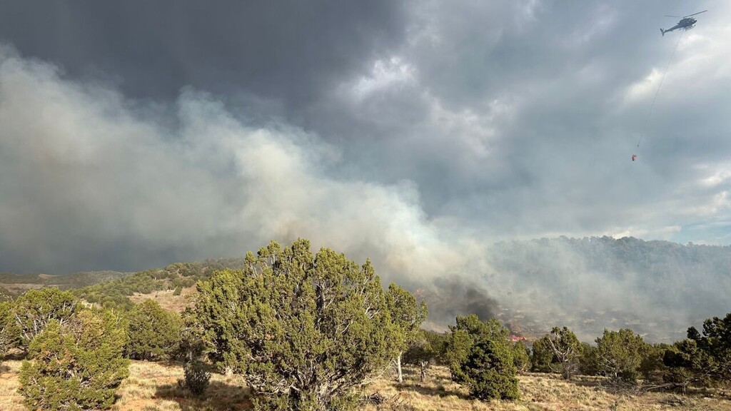 (Utah Fire Info via FOX 13 News) Smoke rises Sunday, May 24, 2026, from the Christy Lane Fire in Iron County.