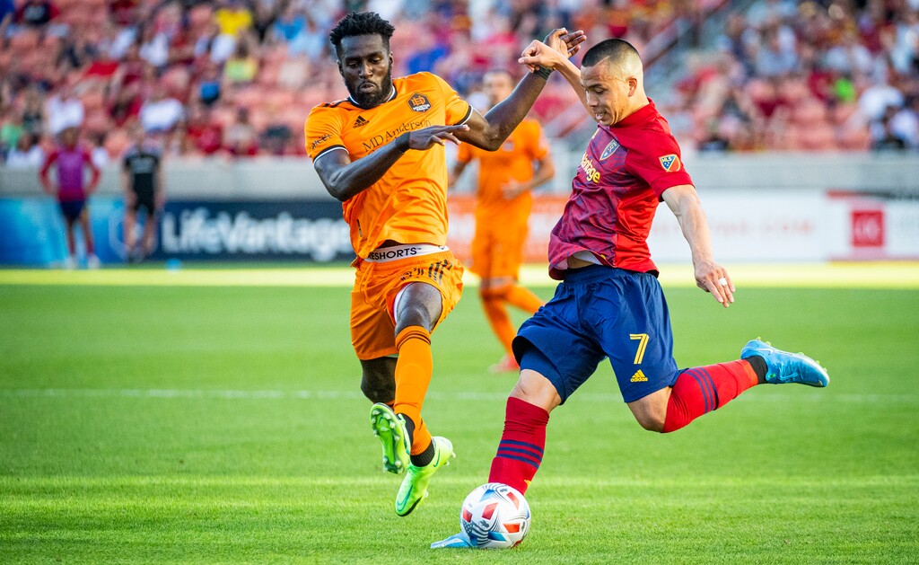 (Isaac Hale | Special to The Tribune) Real Salt Lake forward Bobby Wood (7) passes the ball upfield past Houston Dynamo midfielder Derrick Jones (21) during a MLS game between Real Salt Lake and Houston Dynamo FC at Rio Tinto Stadium in Sandy on Saturday, June 26, 2021.