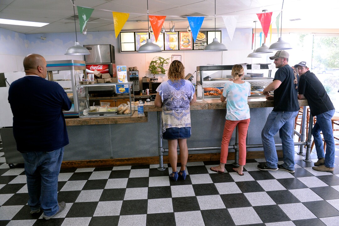 (Al Hartmann  |  The Salt Lake Tribune)  A steady line of loyal customers line the counter at Kevin's Fried Chicken, located inside the Food Mart/Gas Station at 524 W. 4500 South in Murray.  Owner Kevin Nguyen has a secret recipe for the spicy breading, using real chicken pieces (not pressed).  He sells chicken strips, pieces, chicken sandwiches and amazing potato wedges.