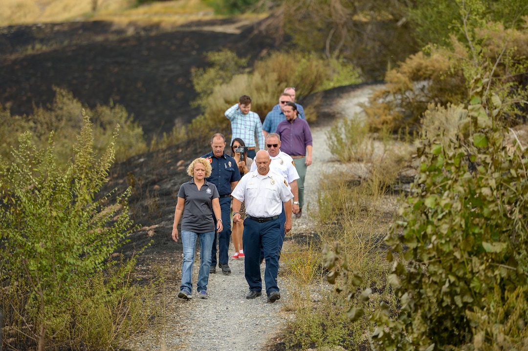 Leah Hogsten  |  The Salt Lake Tribune  l-r Salt Lake City Mayor Jackie Biskupski and Salt Lake City Fire Chief Karl Lieb tour the burned areas near Salt Lake City’s Ensign Peak. Five people were injured and one home was damaged by a fast-moving grass fire on Columbus Court, Tuesday, July 24, 2018. Forty homes were evacuated as flames spread through about 100 acres. Between 50 and 60 firefighters responded to the fire.