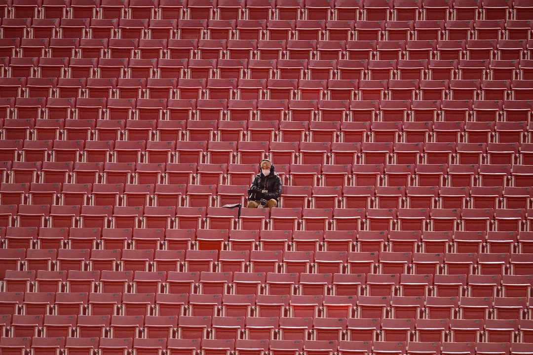 (Trent Nelson  |  The Salt Lake Tribune) A photographer surrounded by empty seats as the Utah Utes host the USC Trojans, NCAA football at Rice-Eccles Stadium in Salt Lake City on Saturday, Nov. 21, 2020.