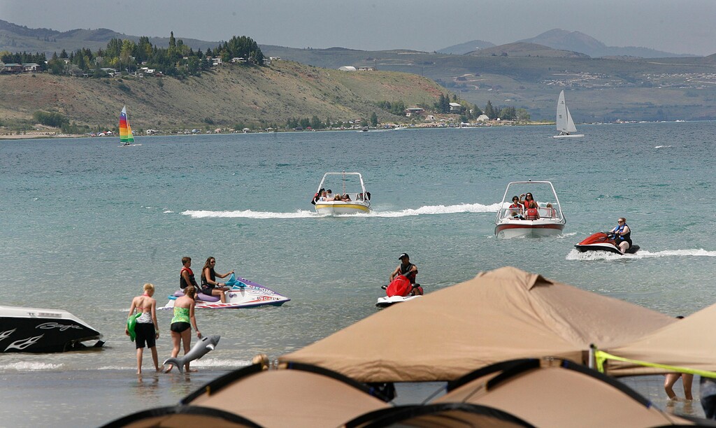 Scott Sommerdorf  l  The Salt Lake Tribune

Boats, jetskis and sailboats ply the waters off Rendezvous Beach State Park on the south end of Bear Lake, Saturday, July, 3, 2010.