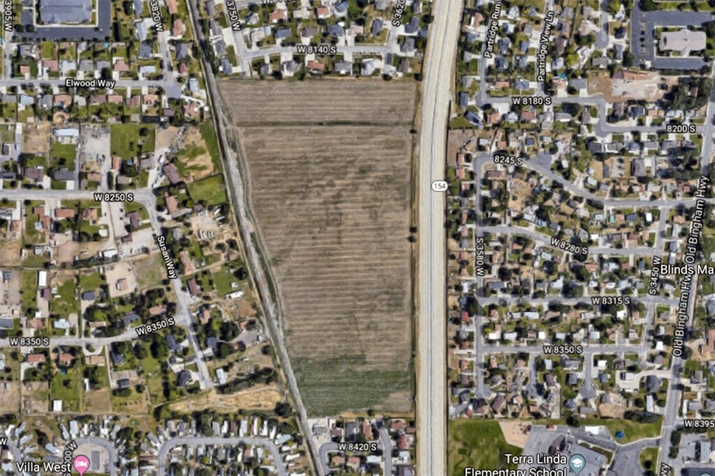 A Google map satellite view showing a West Jordan field to be developed by Bryson Garbett, a homebuilder who is a former legislator. The Legislature took an unusual step to order an $800,000 sound barrier to be built along its border with Bangerter Highway.
