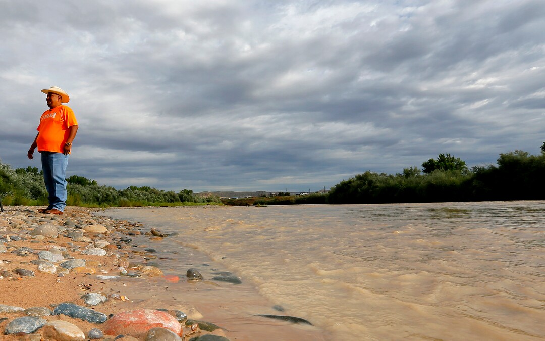 Navajo Nation Council Delegate Davis Filfred walks along the San Juan River, Tuesday, Aug. 11, 2015, in Montezuma Creek, Utah. A spill containing lead and arsenic from the abandoned Gold King Mine in Silverton, Colo., leaked into the Animas River, which flows into the San Juan River in southern Utah, on Aug. 5. The spill was caused by a mining and safety team working for the EPA.  (AP Photo/Matt York) 