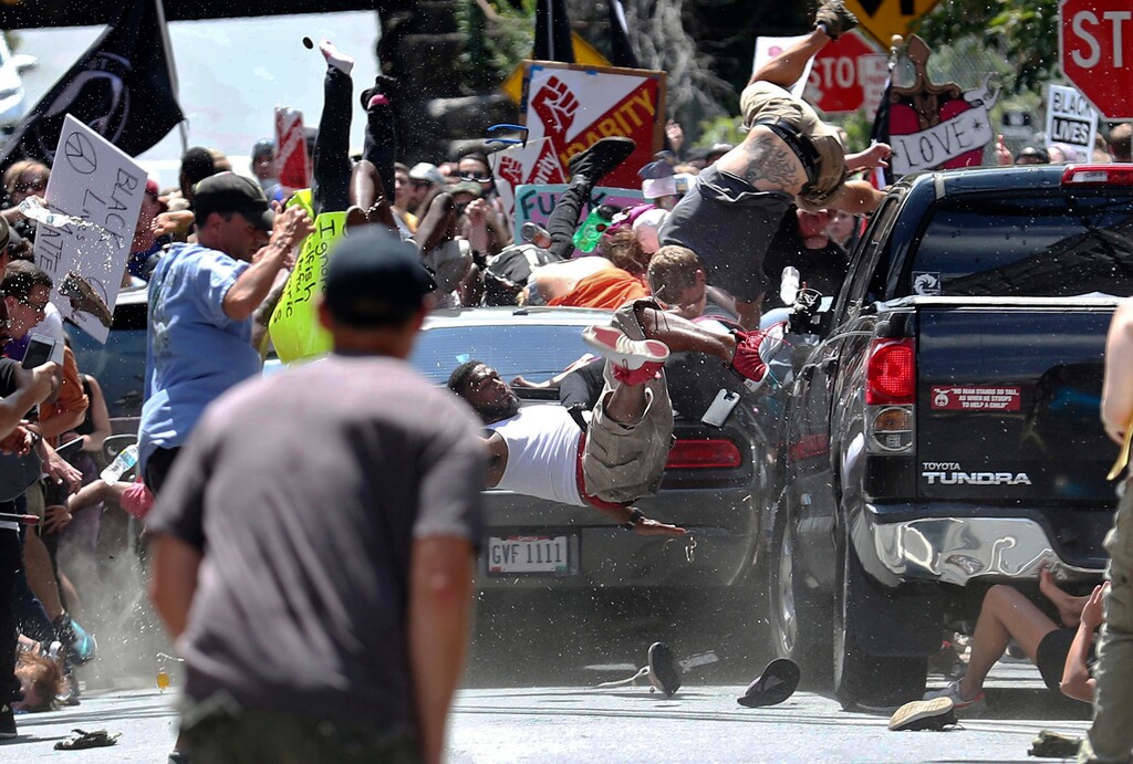 (Ryan M. Kelly  |  The Daily Progress via AP) In this Aug. 12, 2017, file photo, people fly into the air as a vehicle is driven into a group of protesters demonstrating against a white nationalist rally in Charlottesville, Va. Federal hate crime charges have been filed against James Alex Fields Jr., accused of driving the car.