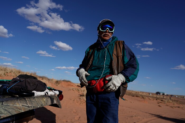 Navajo shepherd Leslie Dele stands next to his all-terrain vehicle as he waits for the sheep to come in on his family ranch outside Tuba City, Ariz., on the Navajo reservation April 22, 2020. The Navajo reservation has some of the highest rates of coronavirus in the country. If Navajos are susceptible to the virus' spread in part because they are so closely knit, that's also how many believe they will beat it. (AP Photo/Carolyn Kaster)