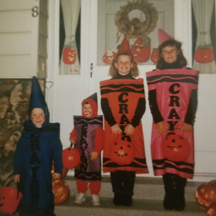 (Bob McCann) Eli McCann at age 6 with his older and younger sisters — all dressed up for Halloween as Crayola crayons.
