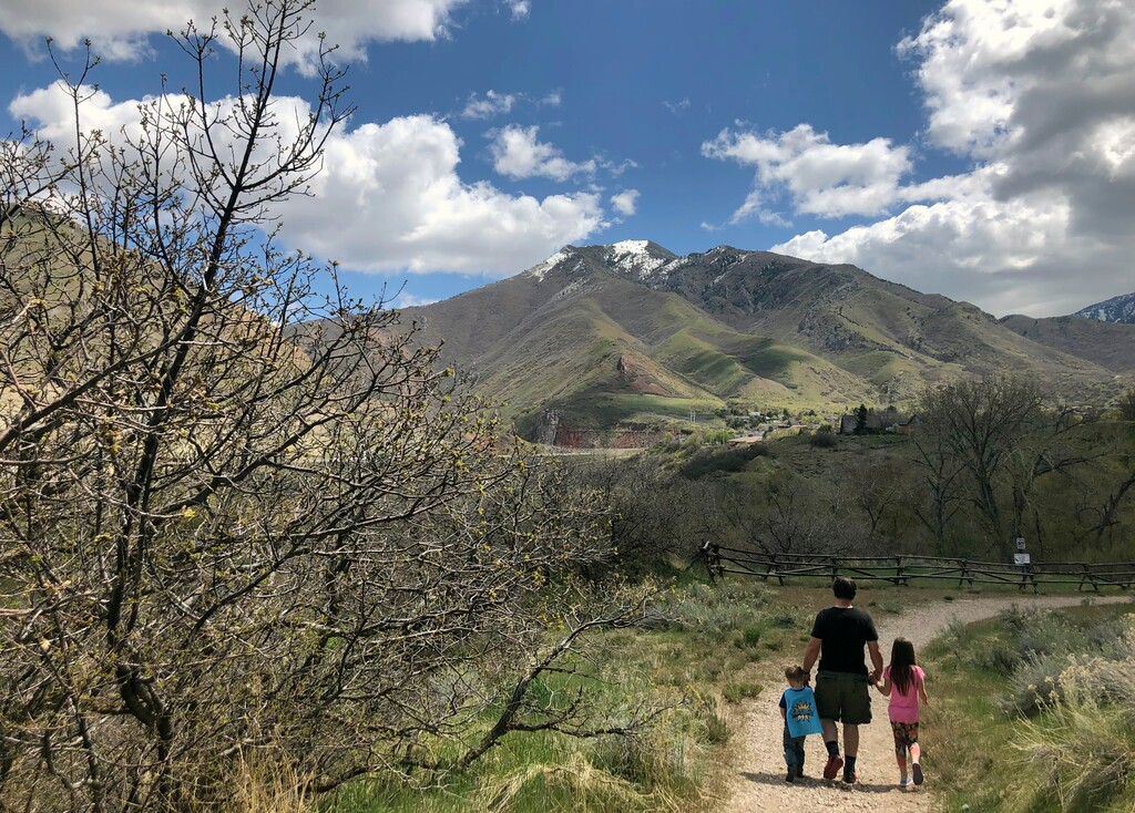 (Lindsay Whitehurst | AP) Associated Press journalist Lindsay Whitehurst's husband, Dave Watson walks with their two children, 3, left, and 5, on a trail in suburban Salt Lake City on April 22, 2020. When the coronavirus pandemic hit, Watson suddenly became a full-time dad. Outside “adventures” became the centerpieces of their days, giving him a front-row seat to the workings of their growing minds.
