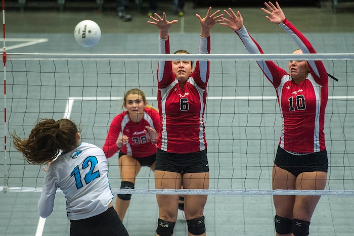 (Chris Detrick  |  The Salt Lake Tribune)  Sky View's Dawson Day (12) spikes past Park City's Emily Smith (6) and Park City's Bella Buchanan (10) during the the 4A volleyball state championships at the UCCU Center at Utah Valley University Thursday, October 26, 2017.  