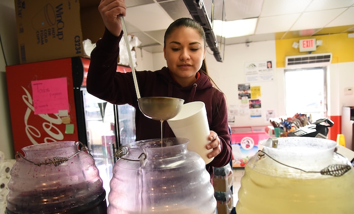 (Francisco Kjolseth  |  The Salt Lake Tribune)  Sandy Vasquez fills drink orders of  limeade, horchata and jamaica at Tacos Mi Caramelo, a late-night taqueria that is open until 2 a.m. most nights and 24-hours a day on Friday and Saturday in West Valley City.