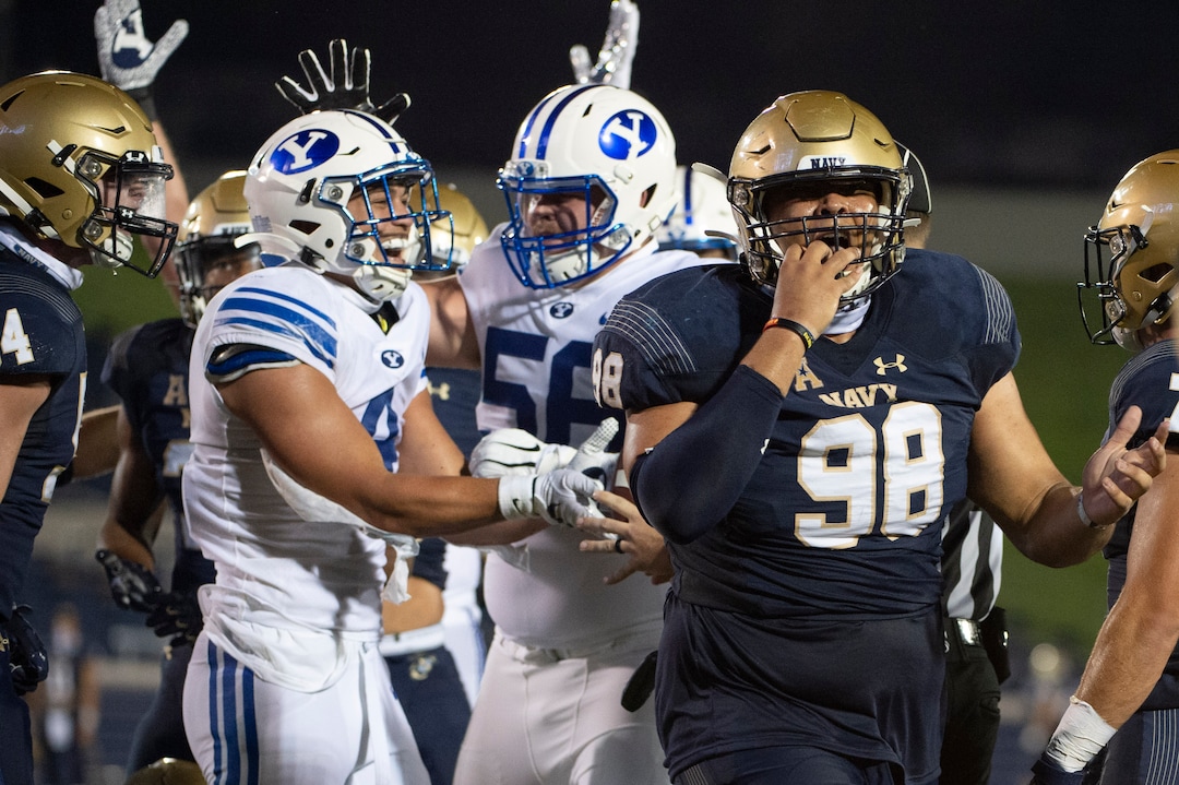 Navy guard Mike Flowers (98) reacts as BYU running back Lopini Katoa (4) celebrates after scoring a touchdown during the first half of an NCAA college football game, Monday, Sept. 7, 2020, in Annapolis, Md. (AP Photo/Tommy Gilligan)