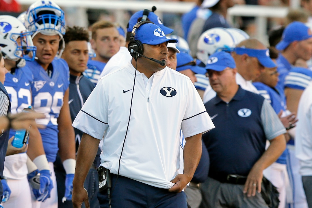 BYU head coach Kalani Sitake, center, looks on during the first half of an NCAA college football game against Utah, Saturday, Sept. 10, 2016, in Salt Lake City. (AP Photo/Rick Bowmer)