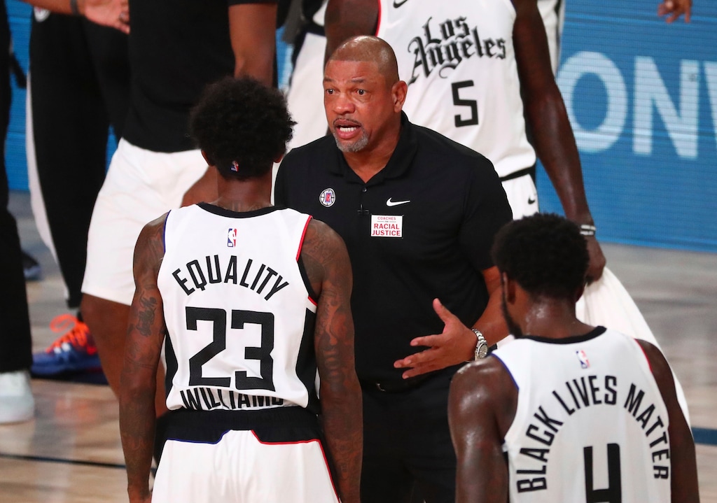 Los Angeles Clippers head coach Doc Rivers talks with guard Lou Williams (23) in the first half of Game 5 of an NBA basketball first-round playoff series, Tuesday, Aug. 25, 2020, in Lake Buena Vista, Fla. (Kim Klement/Pool Photo via AP)