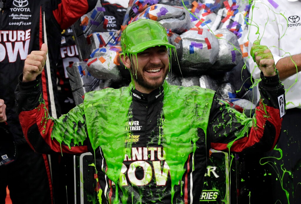 Martin Truex Jr. celebrates with his crew in Victory Lane after winning a NASCAR Cup Monster Energy Series auto race at Chicagoland Speedway in Joliet, Ill., Sunday, Sept. 17, 2017. (AP Photo/Nam Y. Huh)