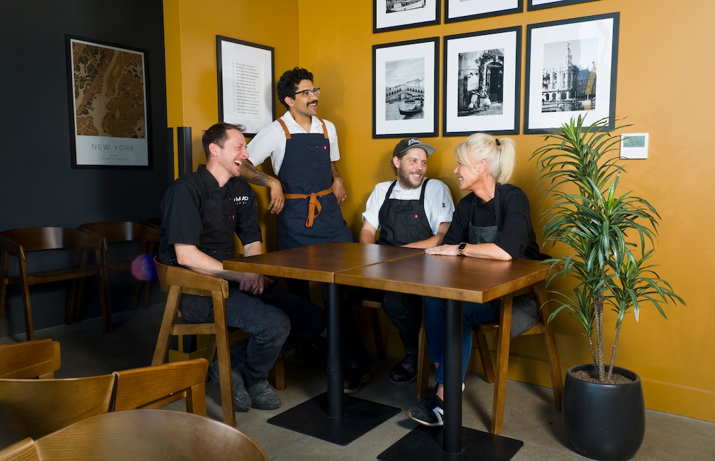 (Bethany Baker | The Salt Lake Tribune) Primary owner Holly Cloyd, right, sits with three of her chefs who she has granted partial ownership of her restaurant, from left, Vance Lott, Diego Najarro and Jonah Foutz at Nomad Eatery in South Jordan on Monday, July 20, 2026.