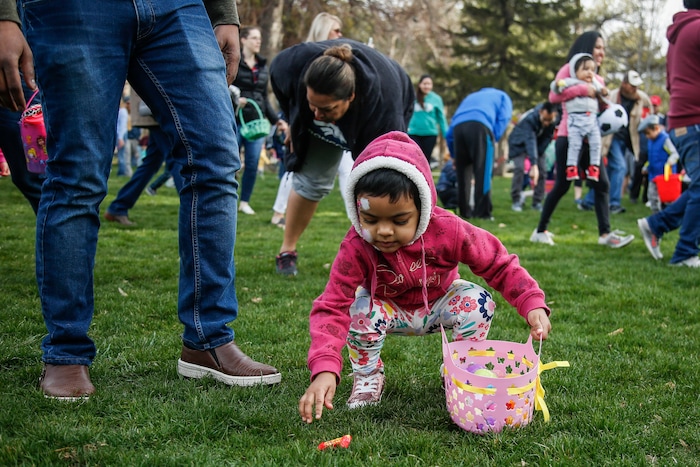 (Nicole Boliaux | For The Tribune) Children and their families run to grab Easter eggs during the annual Easter egg hunt put on by A Kid's Place Dentistry in Liberty Park in Salt Lake City on Saturday, March 31, 2018.