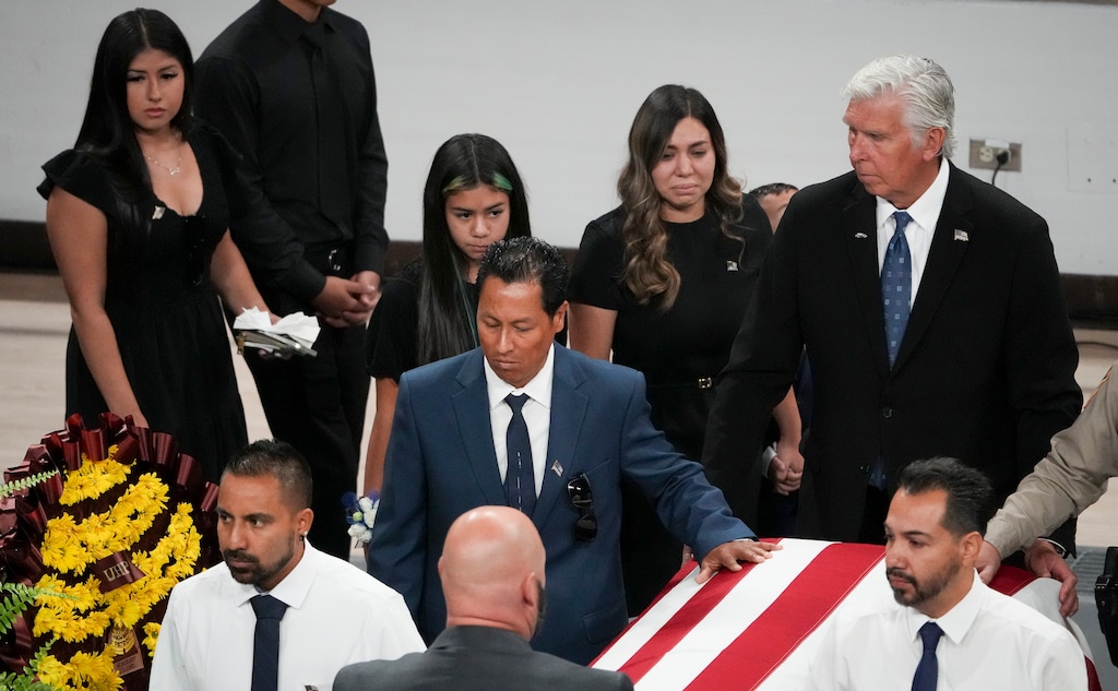 (Bethany Baker | The Salt Lake Tribune) Brittney Estrada, second from right, walks with her children and family behind the casket of her husband, Tremonton-Garland Police Department Officer Eric Estrada, during his funeral service at Utah State University in Logan on Thursday, Aug. 28, 2025.