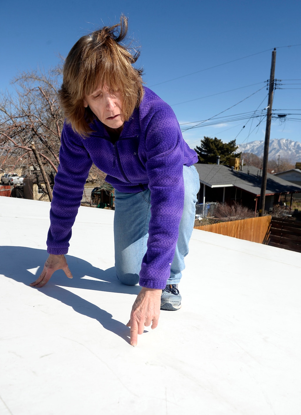 (Al Hartmann | The Salt Lake Tribune)
Teena Johnson signed up for Salt Lake County's Green & Healthy Homes Initiative. What she got was a new, leaky thermoplastic membrane roof. She points to a nail that has worked its way upward through the membrane, allowing moisture in.
