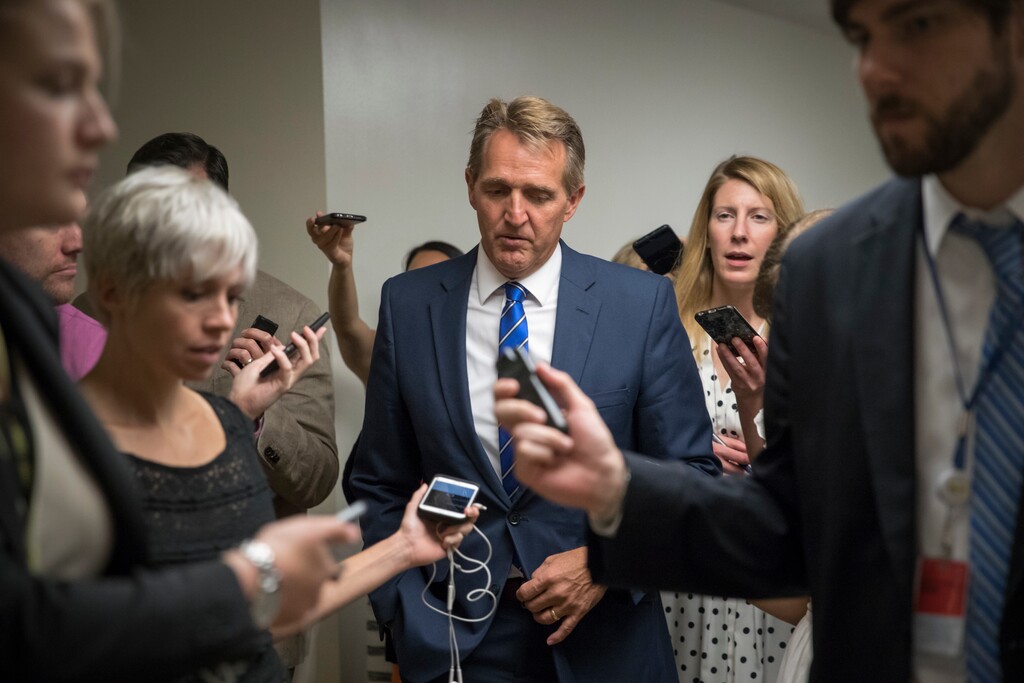 Sen. Jeff Flake, R-Ariz., heads to the chamber for a vote, on Capitol Hill in Washington, Thursday, July 20, 2017. Majority Leader Mitch McConnell is spurring Republican senators to resolve internal disputes that have pushed their marquee health care bill to the brink of oblivion, a situation made more difficult for the GOP because of Sen. John McCain's jarring diagnosis of brain cancer. (AP Photo/J. Scott Applewhite)