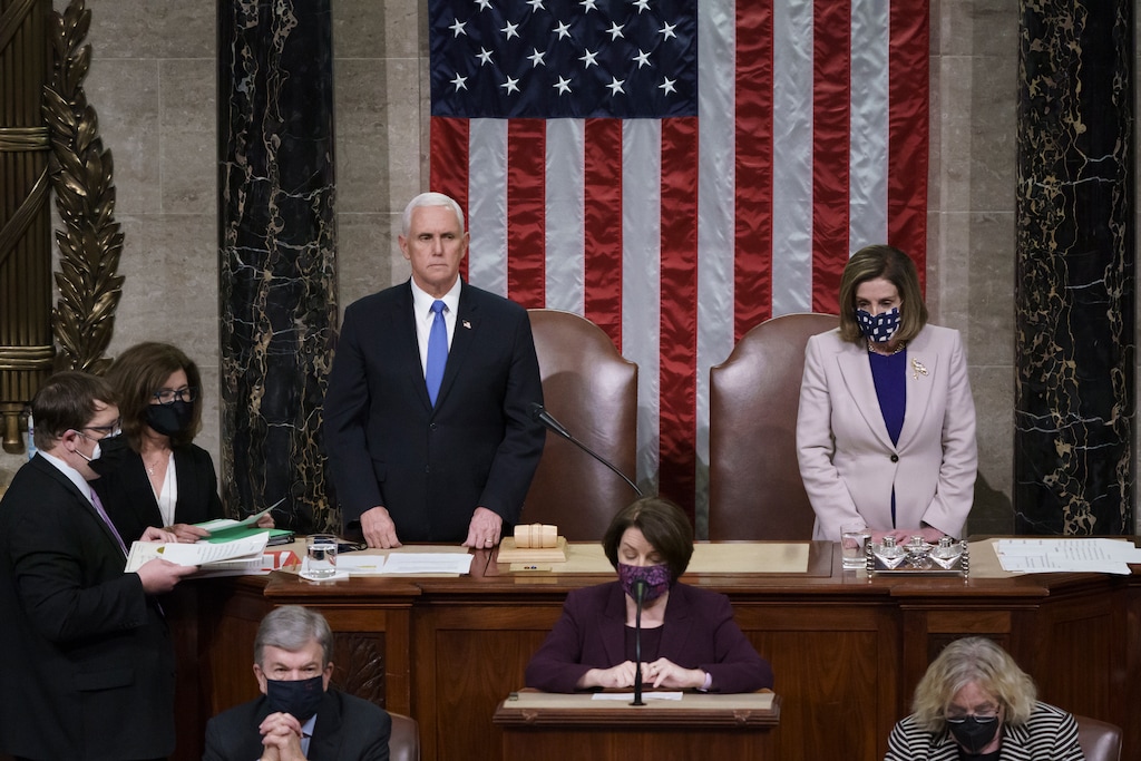 (J. Scott Applewhite | AP file photo) Vice President Mike Pence and Speaker of the House Nancy Pelosi, D-Calif., read the final certification of Electoral College votes cast in November's presidential election during a joint session of Congress after working through the night, at the Capitol in Washington, Thursday, Jan. 7, 2021. Pence and Trump met late Monday for the first time since last week's Capitol attack, a senior administration official said.