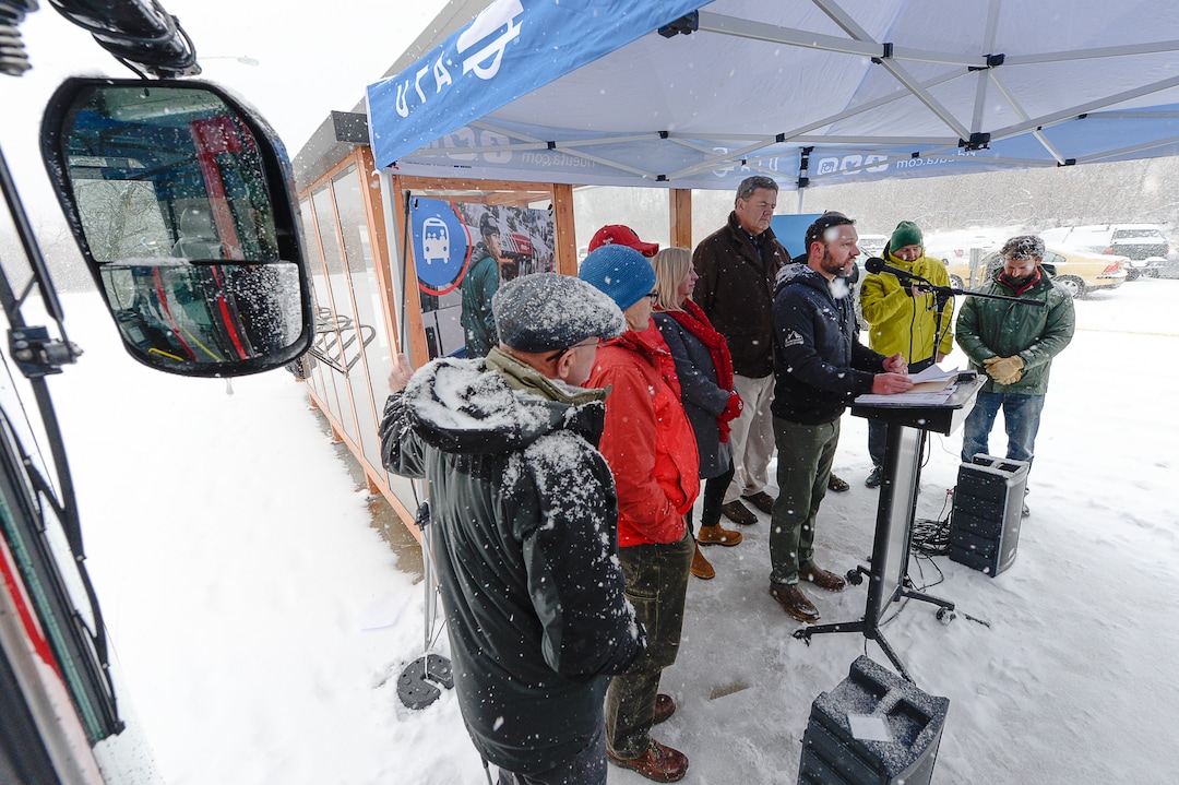 (Francisco Kjolseth  |  The Salt Lake Tribune)  UTA and Central Wasatch Commission members gather at the Big Cottonwood Canyon park and ride lot on Monday, Nov. 25, 2019, as the snow flies to remind residents about improvements to ski buses that will begin service on Nov. 29.