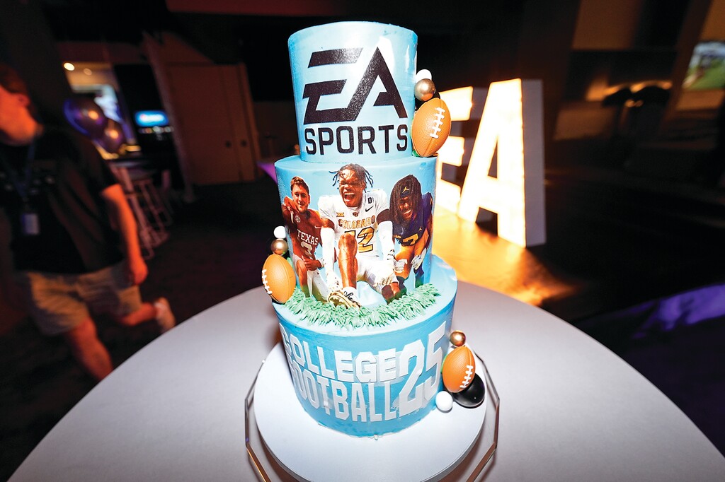 A decoration stands on a table as members of the football team from the University of Colorado play the EA Sports College Football 25 video game during a release party Friday, July 19, 2024, at the Memorial Union on the campus in Boulder, Colo. EA Sports College Football 25 flooded the market Friday as gamers who waited more than a decade for the franchise's next installment hurry to play. (AP Photo/David Zalubowski)