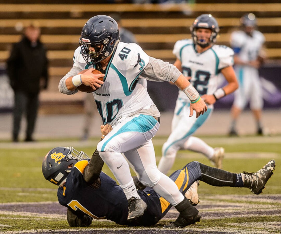 (Trent Nelson | The Salt Lake Tribune)  Juan Diego's Hunter Easterly shakes loose from a Summit Academy defender. Summit Academy faces Juan Diego High School in a class 3A state semifinal football game at Weber State University's Stewart Stadium, Saturday November 4, 2017.