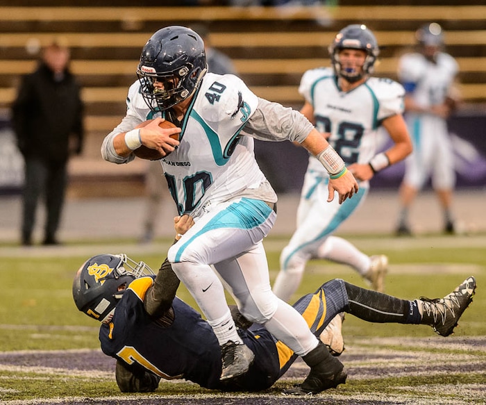 (Trent Nelson | The Salt Lake Tribune)  Juan Diego's Hunter Easterly shakes loose from a Summit Academy defender. Summit Academy faces Juan Diego High School in a class 3A state semifinal football game at Weber State University's Stewart Stadium, Saturday November 4, 2017.