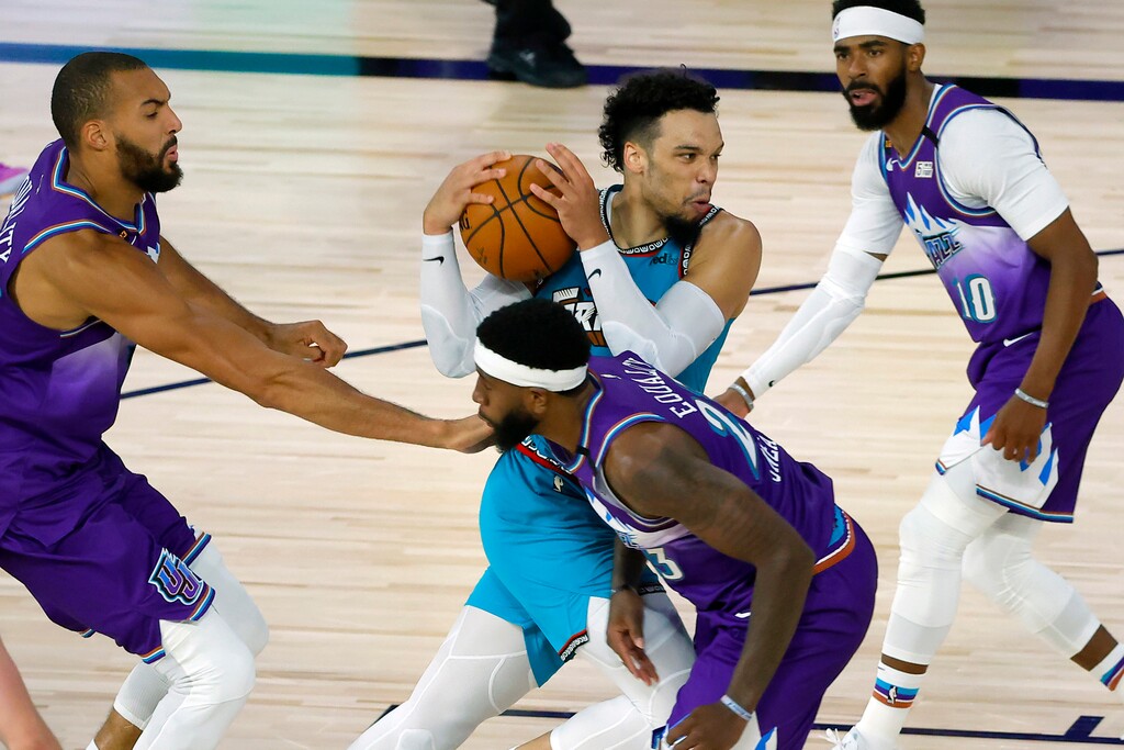 Memphis Grizzlies' Dillon Brooks (24) drives past Utah Jazz's Rudy Gobert (27) of the Utah Jazz during the second half of an NBA basketball game Wednesday, Aug. 5, 2020, in Lake Buena Vista, Fla. (Kevin C. Cox/Pool Photo via AP)