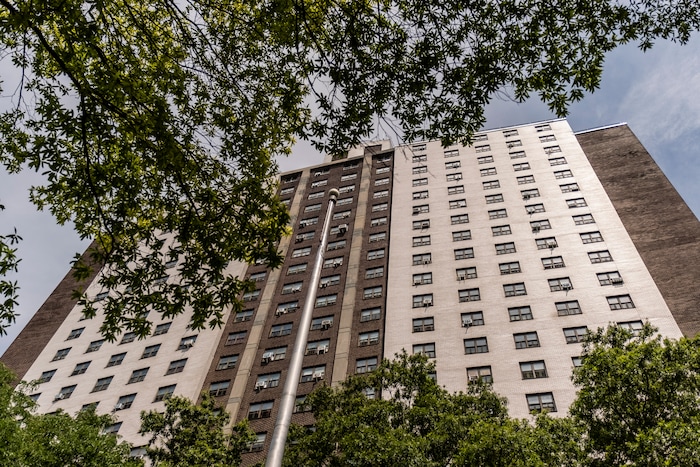 (Juan Arredondo | The New York Times) Air conditioner units hang from the windows of some but not all units at the Carter G. Woodson Senior house in Brooklyn, July 23, 2020. Around the world, the poor and marginalized are much more likely to be vulnerable to extreme heat; Black people and Latinos are far more likely to live in the hottest parts of American cities.
