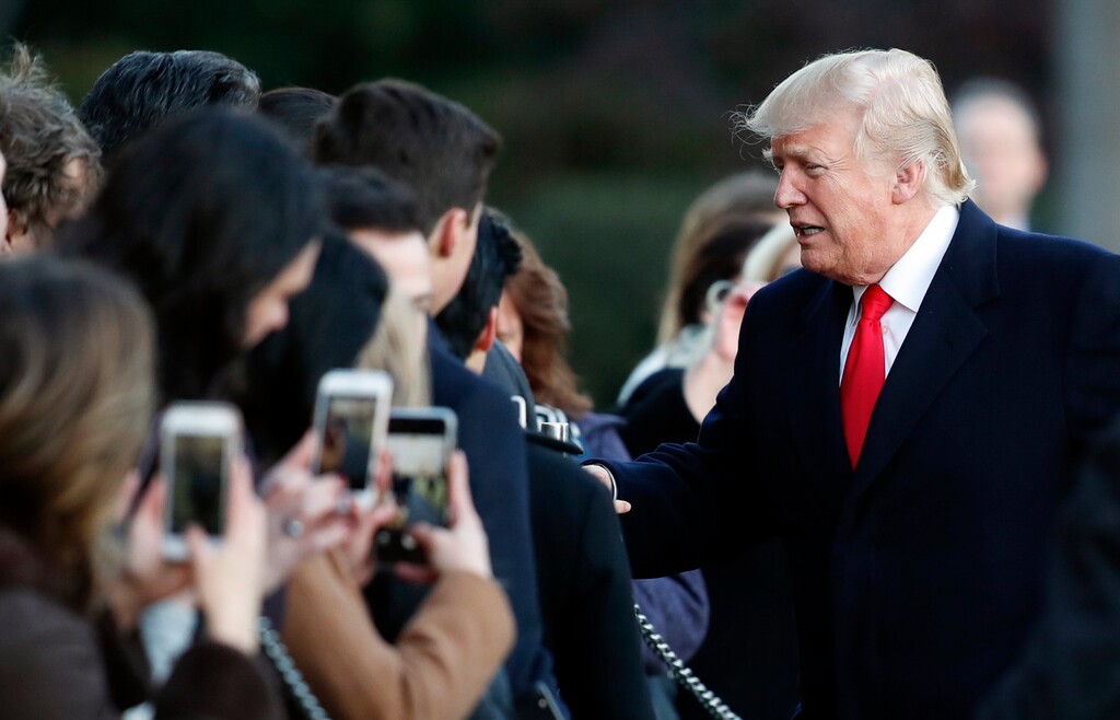 (Carolyn Kaster | The Associated Press) President Donald Trump greets people on the South Lawn to the White House in Washington, Thursday, Jan. 18, 2018, as he returns from Pittsburgh.
