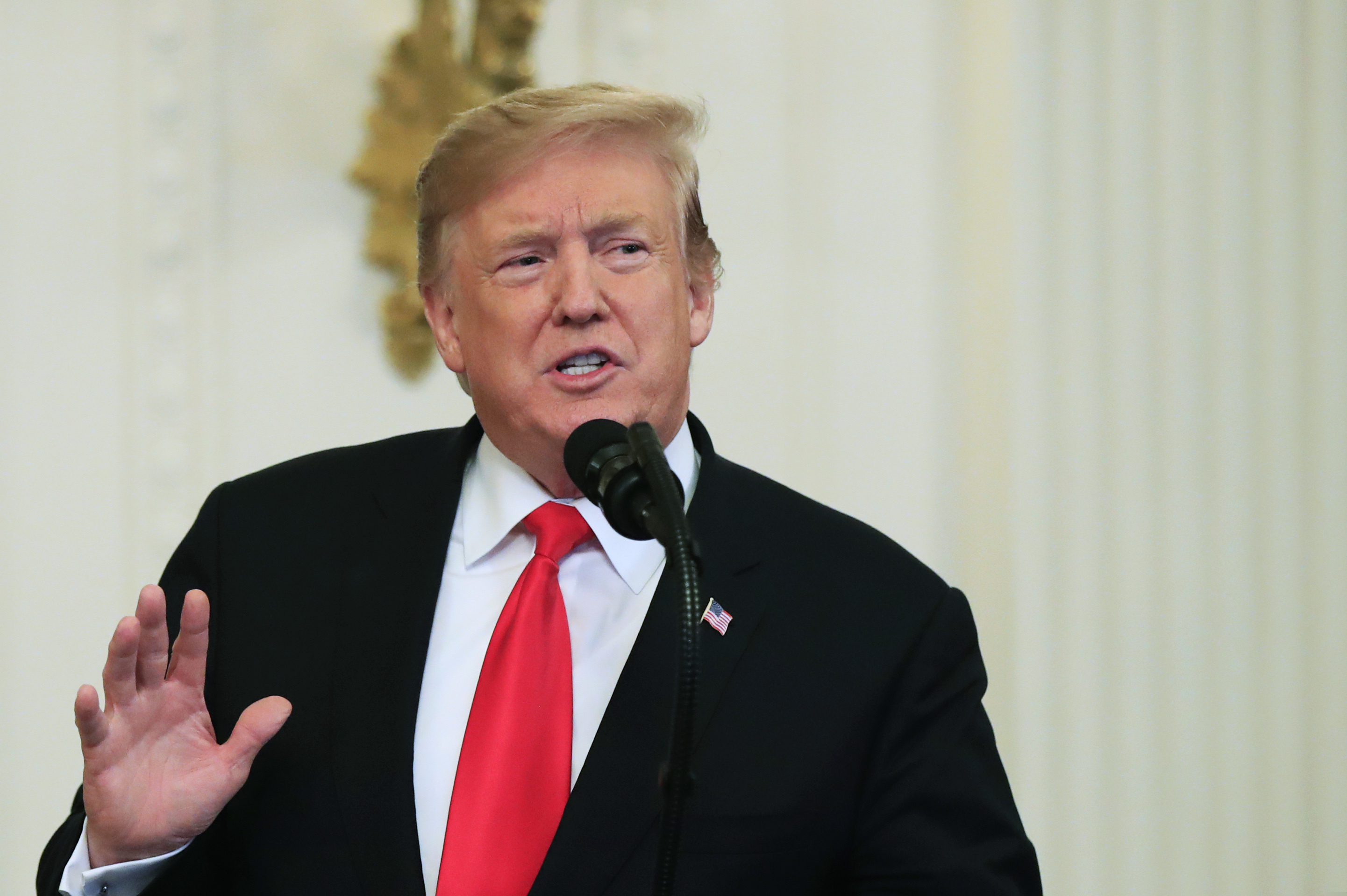President Donald Trump speaks before awarding the Medal of Honor to Army Staff Sgt. Travis Atkins with Atkins' son Trevor Oliver, 22, accepting the posthumous recognition for conspicuous gallantry in Iraq in June 2007, during a ceremony in the East Room of the White House, Wednesday March 27, 2019, in Washington. (AP Photo/Manuel Balce Ceneta)