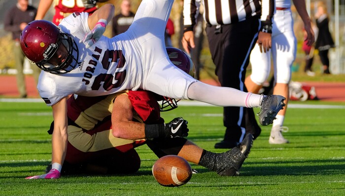 (Leah Hogsten  |  The Salt Lake Tribune) Jordan's Wyatt Jones falls on Viewmont's Jackson Barber. Jordan High School boys' football team defeated Viewmont High School 28-20 during their class 5A football playoff opener, Friday, October 27, 2017 in Bountiful.