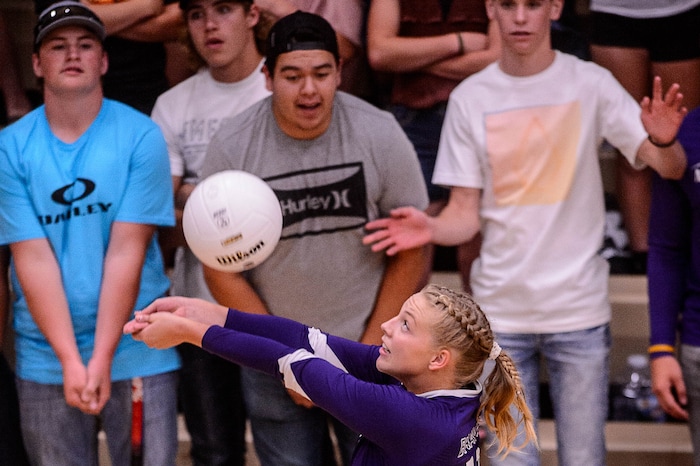 (Trent Nelson  |  The Salt Lake Tribune)  A fan mimics North Summit's Brecklyn Murdock (11) hitting the ball as North Summit hosts Bingham, high school girls' volleyball in Coalville, Thursday August 17, 2017.