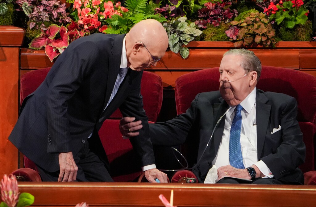 (Chris Samuels | The Salt Lake Tribune) President Dallin H. Oaks, left, receives assistance from apostle Jeffrey R. Holland during a session of General Conference on Oct. 5, 2025.