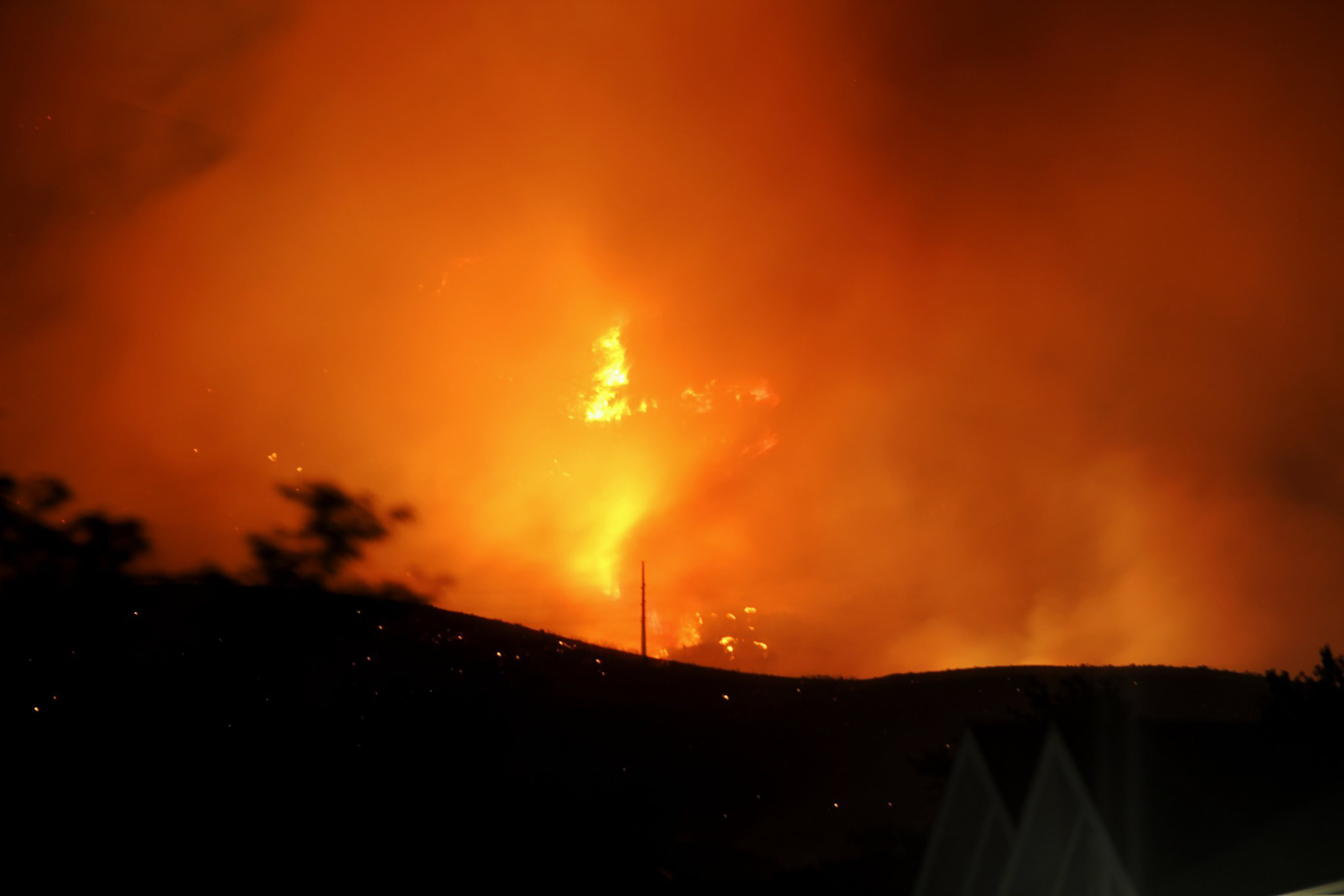 The Traverse Fire burns near homes in Lehi, Utah, Sunday, June 28, 2020. Officials say fireworks caused the wildfire and forced evacuations early Sunday morning. (Justin Reeves via AP)