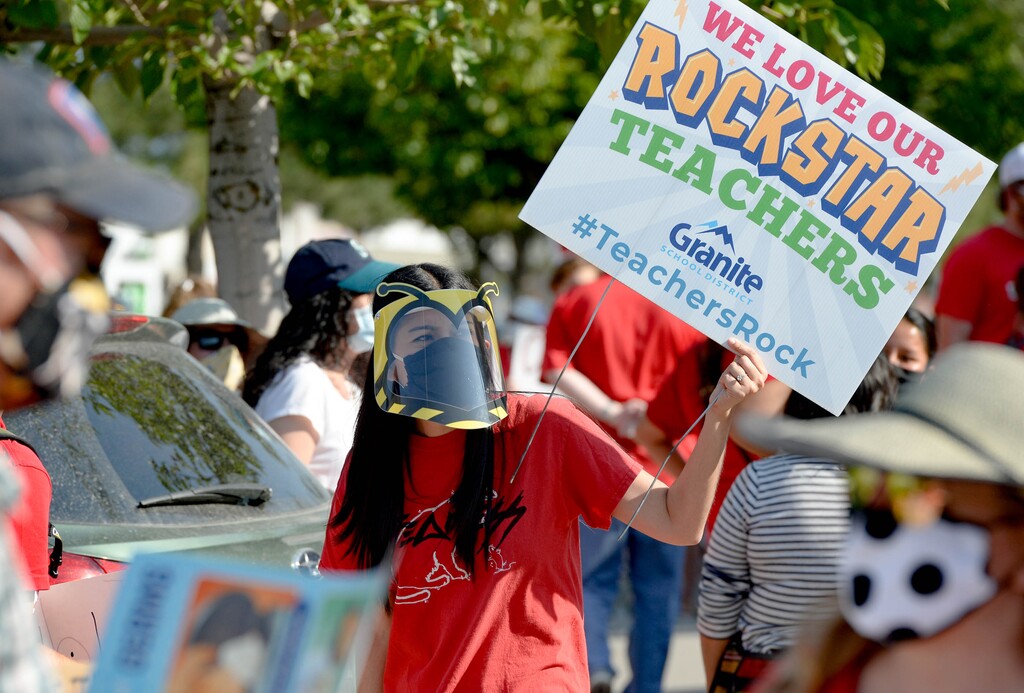 (Francisco Kjolseth  |  The Salt Lake Tribune) Sellika Reese, a first grade English teacher who teaches phonics, wears what she would need to teach which would make it very difficult for her students to understand her as she joined hundreds of Granite School district teachers gathered at the Granite School District office on Tuesday, August 4, 2020. The teachers were protesting the district’s plans for reopening, which will allow students back into the classroom, like normal, five days a week.