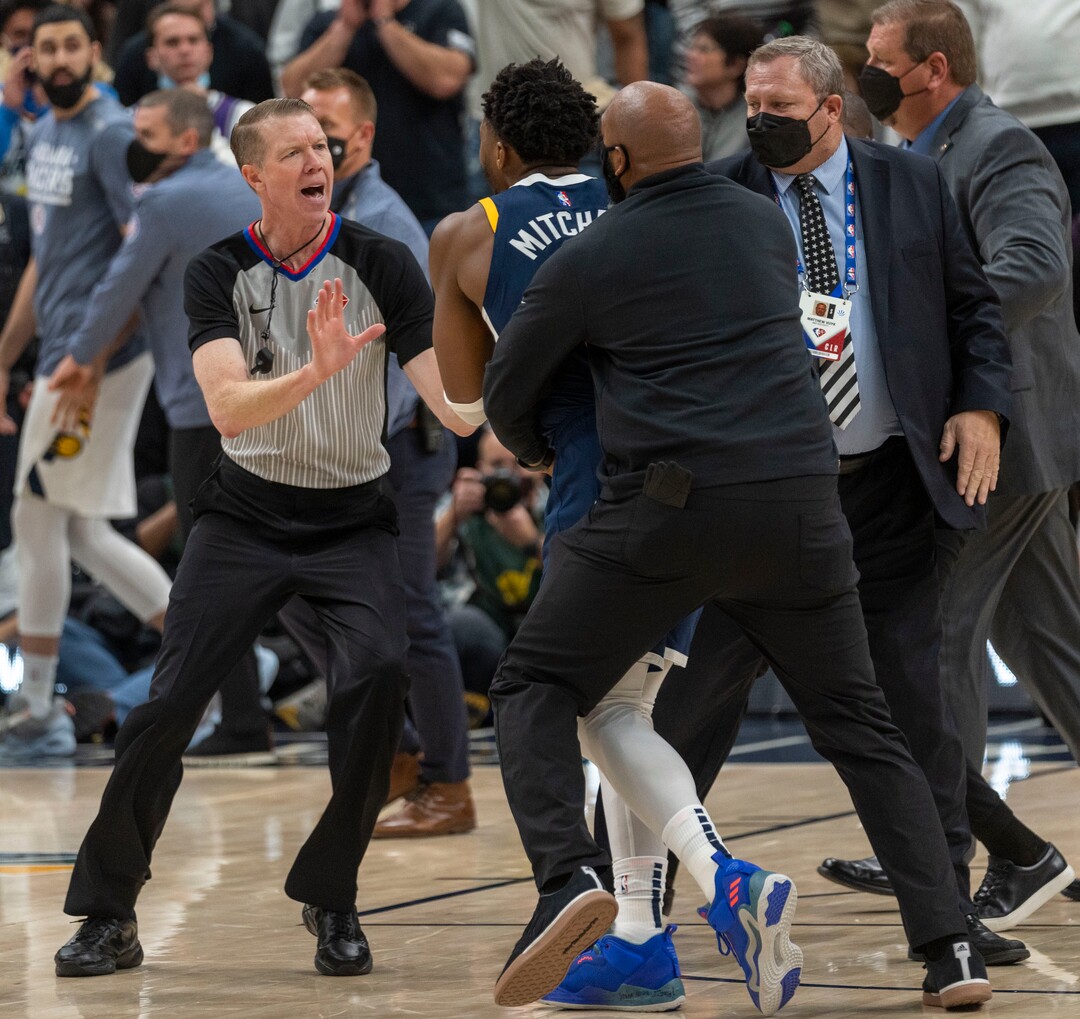 (Rick Egan | The Salt Lake Tribune) Referee Ed Malloy tries to stop Utah Jazz guard Donovan Mitchell (45) from getting to the Indiana Pacers bench after Indiana center Miles Turner scuffled with Jazz center Rudy Gobert, resulting in 4 ejections, in the 4th quarter, in NBA action between Utah Jazz and Indiana Pacers at Vivint Arena, on Thursday, Nov. 11, 2021.
