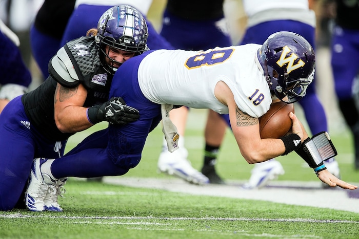 (Chris Detrick  |  The Salt Lake Tribune)  Weber State Wildcats defensive lineman Cardon Malan (44) sacks Western Illinois Leathernecks quarterback Sean McGuire (18) during the game at Stewart Stadium Saturday, November 25, 2017.  