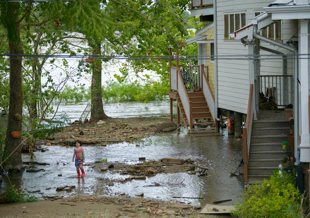 (Matthew Hinton | AP Photo) Delilah Campbell, 4, clears out driftwood and other debris in preparation of Tropical Storm Barry near New Orleans, La., Thursday, July 11, 2019. The area is normally a driveway at her family's home that is one of the few on land called batture on the outside of the Mississippi River levee at the border of Orleans and Jefferson Parishes. The family removes the debris to prevent hearing clanging against the foundation pilings of the raised home.