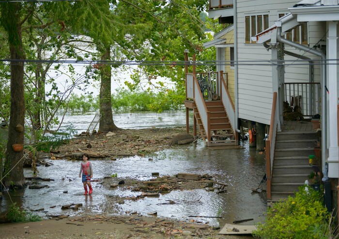 (Matthew Hinton | AP Photo) Delilah Campbell, 4, clears out driftwood and other debris in preparation of Tropical Storm Barry near New Orleans, La., Thursday, July 11, 2019. The area is normally a driveway at her family's home that is one of the few on land called batture on the outside of the Mississippi River levee at the border of Orleans and Jefferson Parishes. The family removes the debris to prevent hearing clanging against the foundation pilings of the raised home.