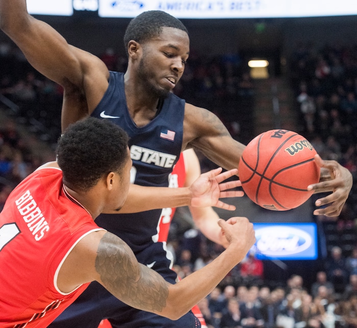 (Rick Egan  |  The Salt Lake Tribune)  Utah State Aggies guard DeAngelo Isby (0) deflects a pass from Utah Utes guard Justin Bibbins (1), in Beehive Classic basketball action at the Vivint SmartHome Arena, Saturday, December 9, 2017.