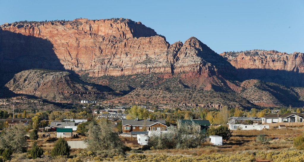 (Rick Bowmer | Associated Press file photo) This Oct. 26, 2017, file photo shows Hildale, Utah, sitting at the base of Red Rock Cliff mountains, with its sister city, Colorado City, Ariz., in the foreground. Six of seven municipal workers for the town of Hildale, Utah, quit after Mayor Donia Jessop was elected and took charge of the local government run by the sect for more than a century.