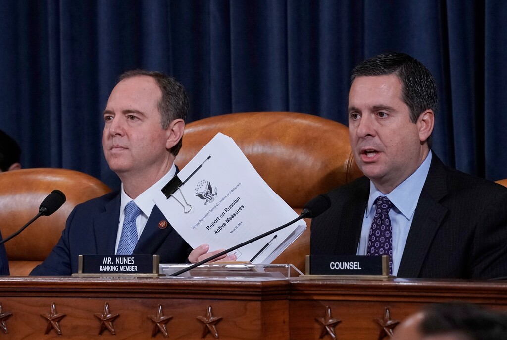(J. Scott Applewhite | AP File Photo) Rep. Devin Nunes, R-Calif., the ranking member of the House Intelligence Committee, joined at left by Chairman Adam Schiff, D-Calif., holds up a document he is submitting as the panel prepares to listen to former White House national security aide Fiona Hill, and David Holmes, a U.S. diplomat in Ukraine, on Capitol Hill in Washington, Thursday, Nov. 21, 2019, during a public impeachment hearing of President Donald Trump's efforts to tie U.S. aid for Ukraine to investigations of his political opponents.