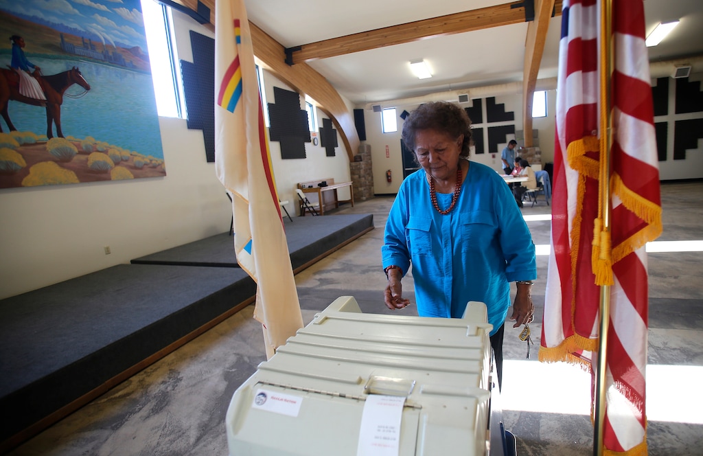 (Jon Austria | The Daily Times via AP, file) Martha Johnson turns in her ballot at the Nenahnezad Chapter House in Fruitland, N.M., during the Navajo Nation's referendum election, July 21, 2015. Native American voting rights advocates are cautioning against states moving to mail-in ballots without opportunities for tribal members to vote safely in person. The Native American Rights Fund released a wide-ranging report on voting rights Thursday, June 4, 2020. In it, the group outlined the challenges that could arise as states move to rely more heavily on mail-in ballots.