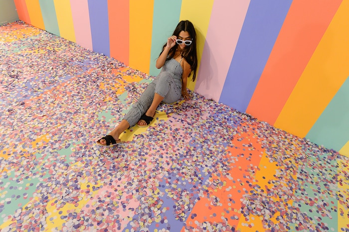 (Francisco Kjolseth  |  The Salt Lake Tribune)  Riley Gracie poses for a friend's camera in the cereal room at Hall of Breakfast, a quirky new art exhibit that celebrates the first meal of the day. The exhibit runs through July 9 at The Gateway.