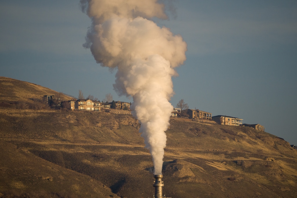 (Trent Nelson | The Salt Lake Tribune) Emissions from a Salt Lake City area refinery during a hazy inversion in December 2023. Utah's carbon dioxide emissions, which cause climate change, average out to about 18 tons per person per year. The global average is below 5 tons.