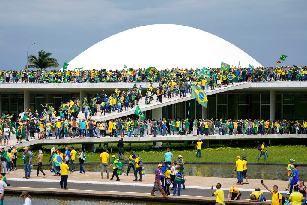 (Eraldo Peres | AP) Protesters, supporters of Brazil's former President Jair Bolsonaro, storm the the National Congress building in Brasilia, Brazil, Sunday, Jan. 8, 2023.