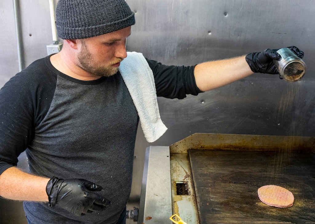 (Rick Egan | The Salt Lake Tribune)  Jon Humes cooks a Dank Burger at Feed Me, a new late-night ghost kitchen in Salt Lake City. Thursday, June 23, 2022.