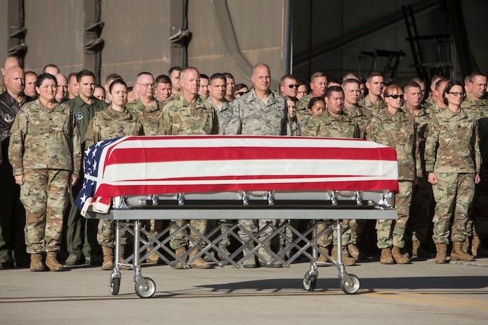 (Matt Herp | The Ogden Standrad Examiner/Pool) Members of the Utah National Guard stand attention as a casket containing the remains of Maj. Brent R. Taylor arrives at Roland R. Wright Air National Guard Base in Salt Lake City, Utah, on Wednesday, Nov. 14, 2018. Taylor, 39, of North Ogden, died Nov. 3, 2018, in Afghanistan of wounds sustained from small arms fire. His funeral is scheduled for Saturday, Nov. 17, in Ogden.